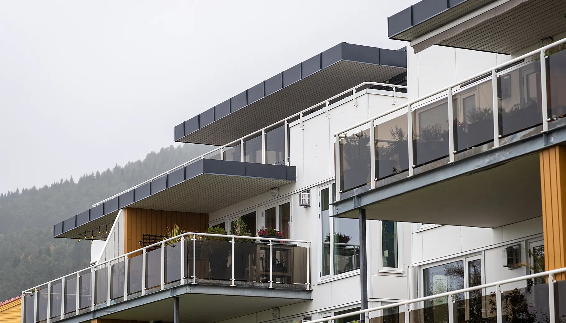 Moderne leilighetsbygg i Sameiet Glomstuveien på Bjørset i Molde, omgitt av grønne omgivelser med kort vei til sentrum, fjord og turområder.